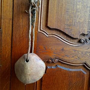 Primative cow bell made from cocnut shell.